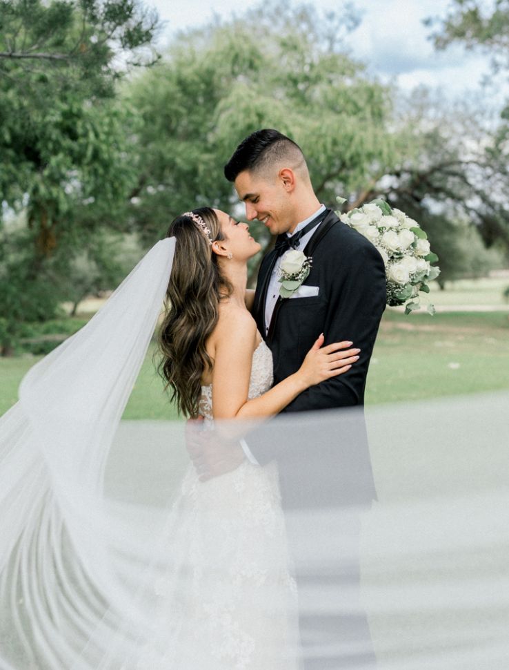 bride and groom with veil flowing at Tucson Wedding venue, La Mariposa Resort