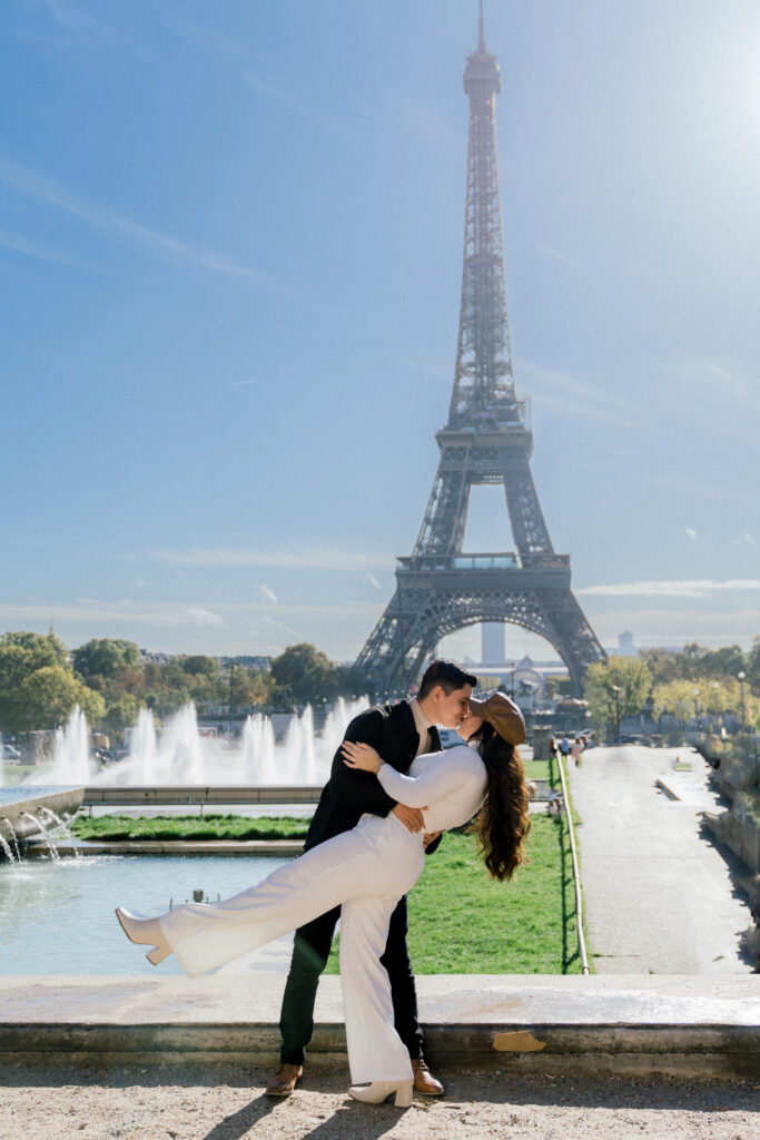Anniversary session in Paris. Couple posing in front of the Eiffel Tower. Ruby Sandoval Photography.