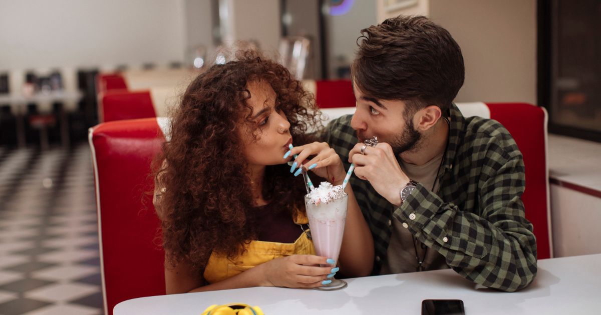 a couple sharing a milkshake during a Tucson date idea.