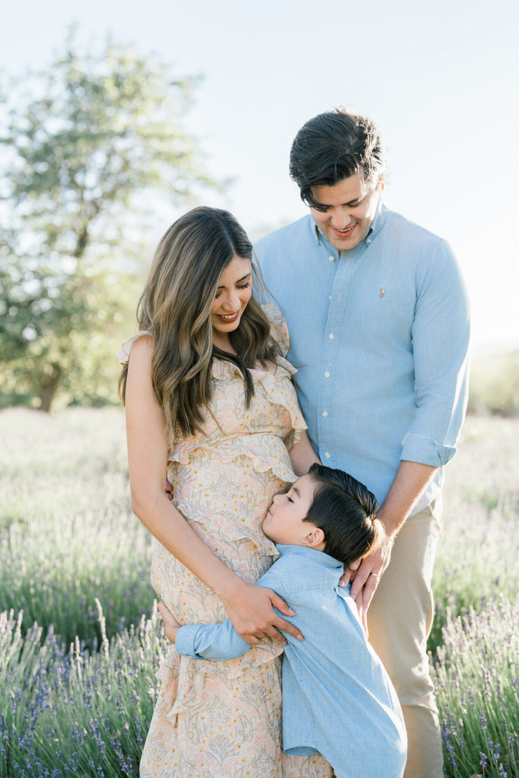 Couple with son hugging pregnant mom during a Tucson maternity session